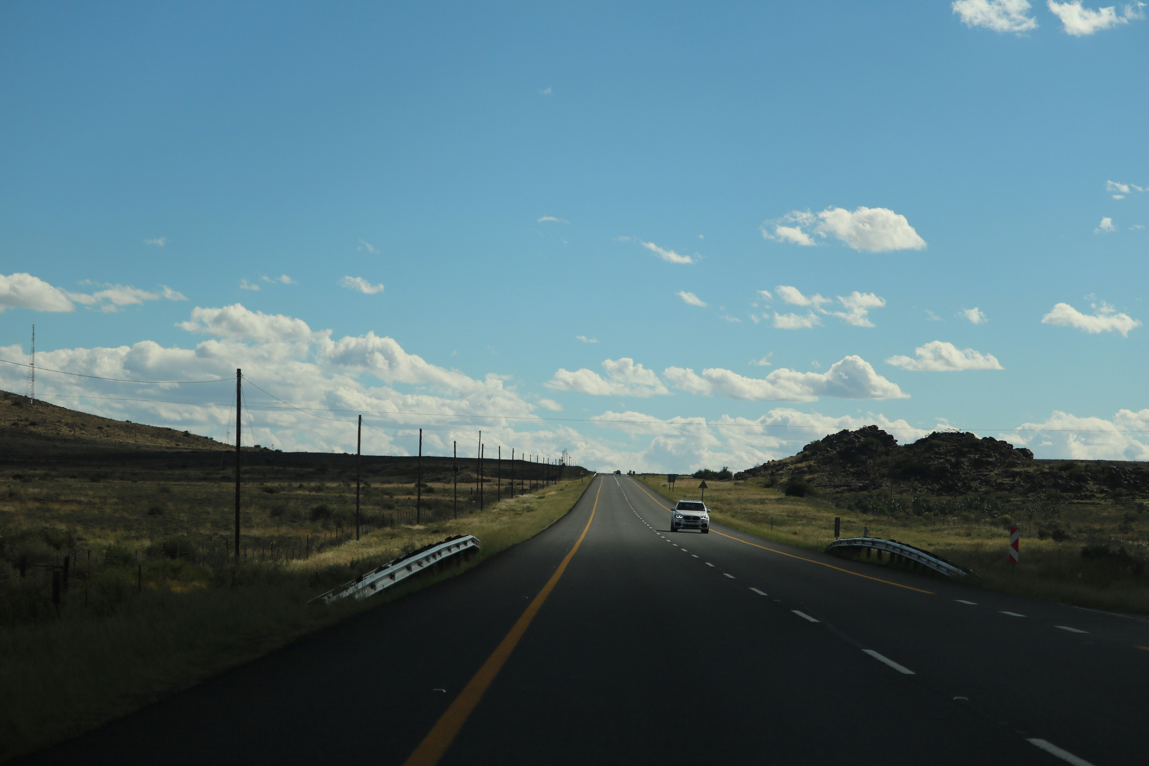 Car on a scenic open highway for outstation journeys